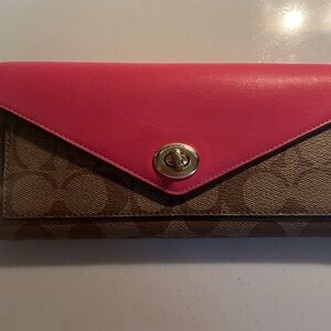 Never carried Coach wallet in signature fabric with pink accents.